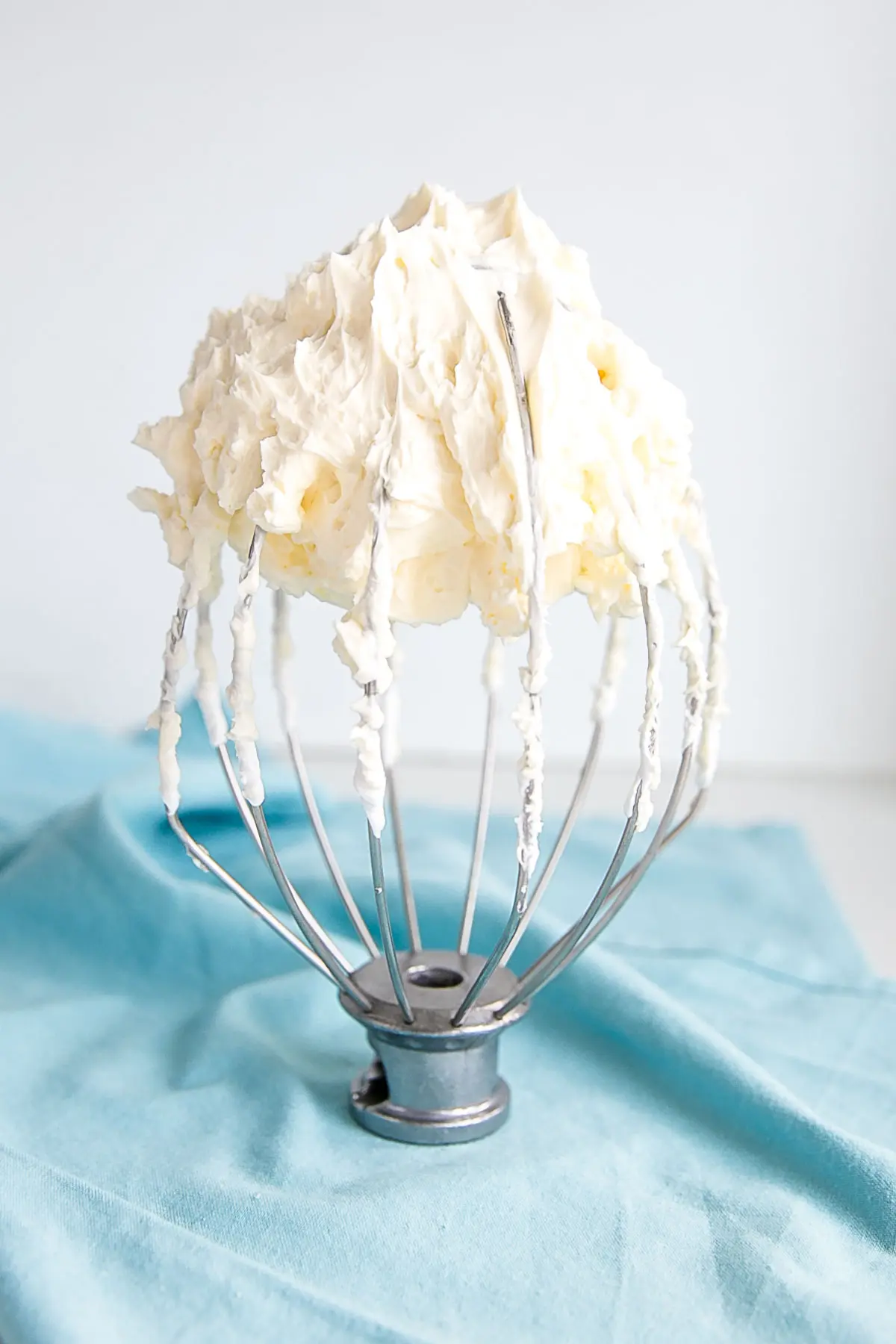 Swiss meringue buttercream on a whisk different angle.