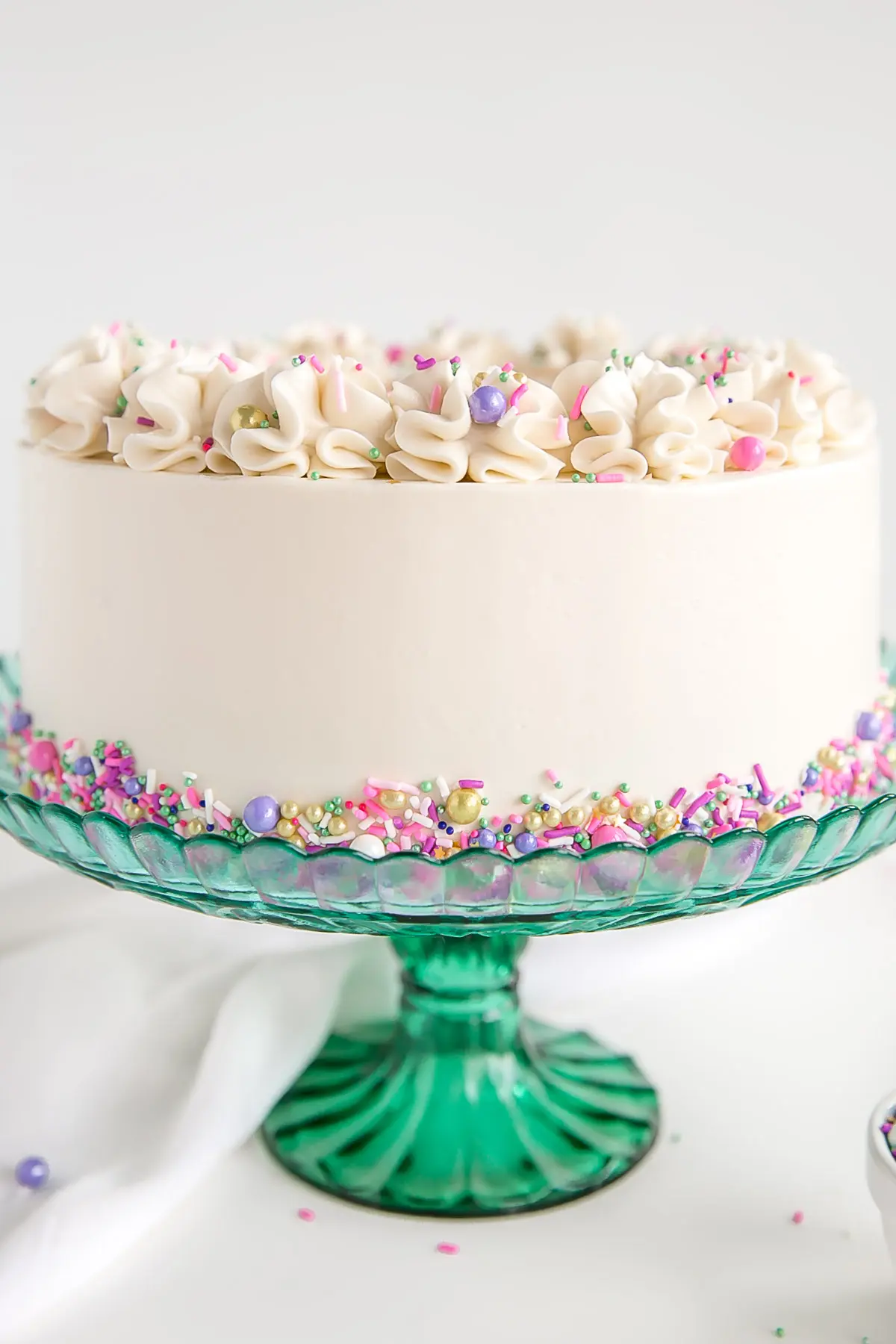 Close up of white buttercream on a white cake.
