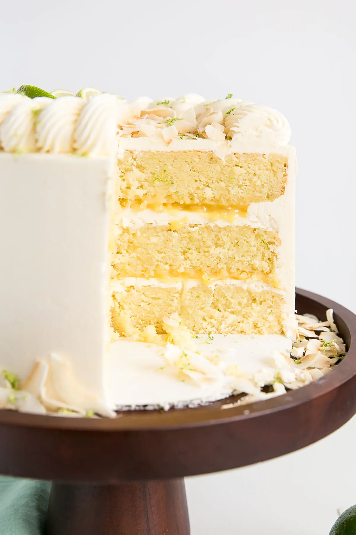 Three-layer coconut lime cake with homemade lime curd and silky coconut buttercream.