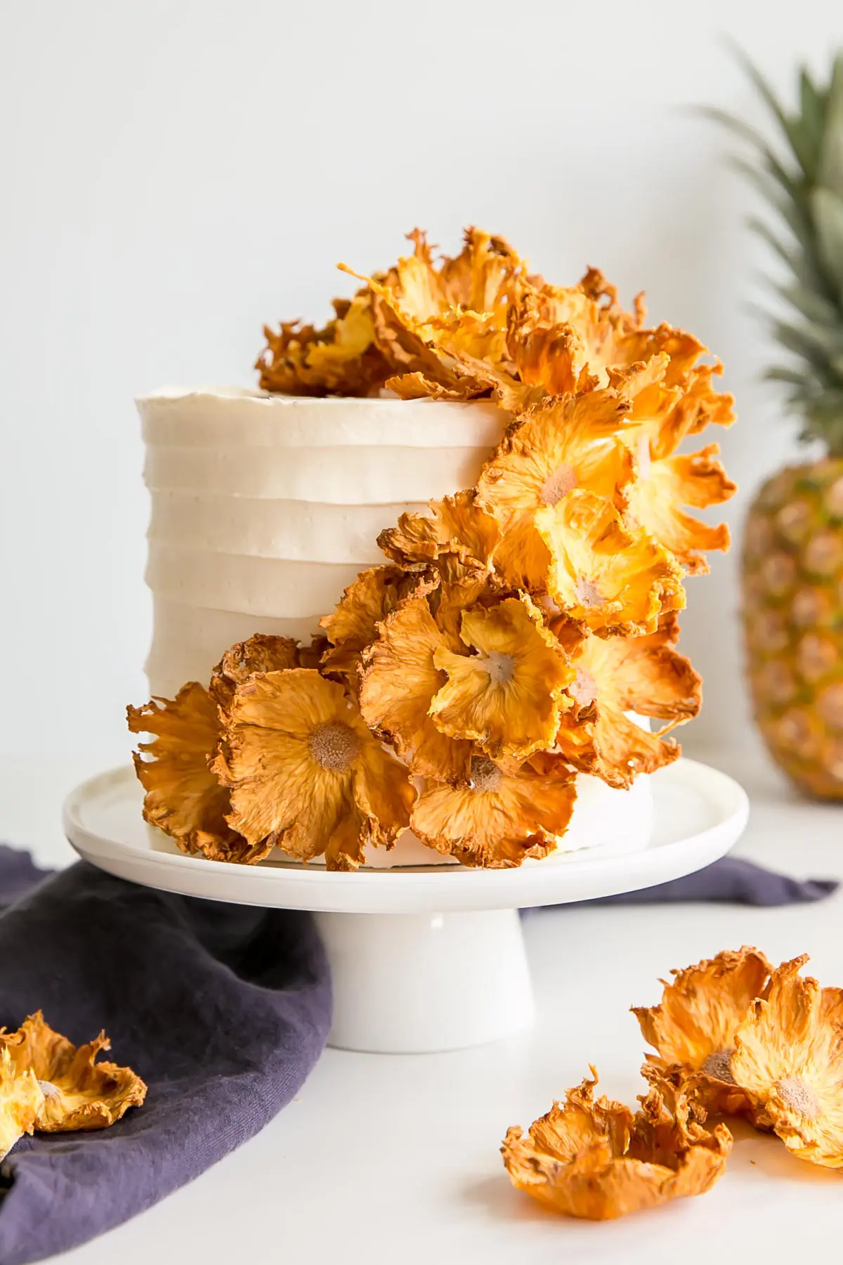 Pineapple cake with pineapple buttercream covered with dehydrated pineapple flowers.