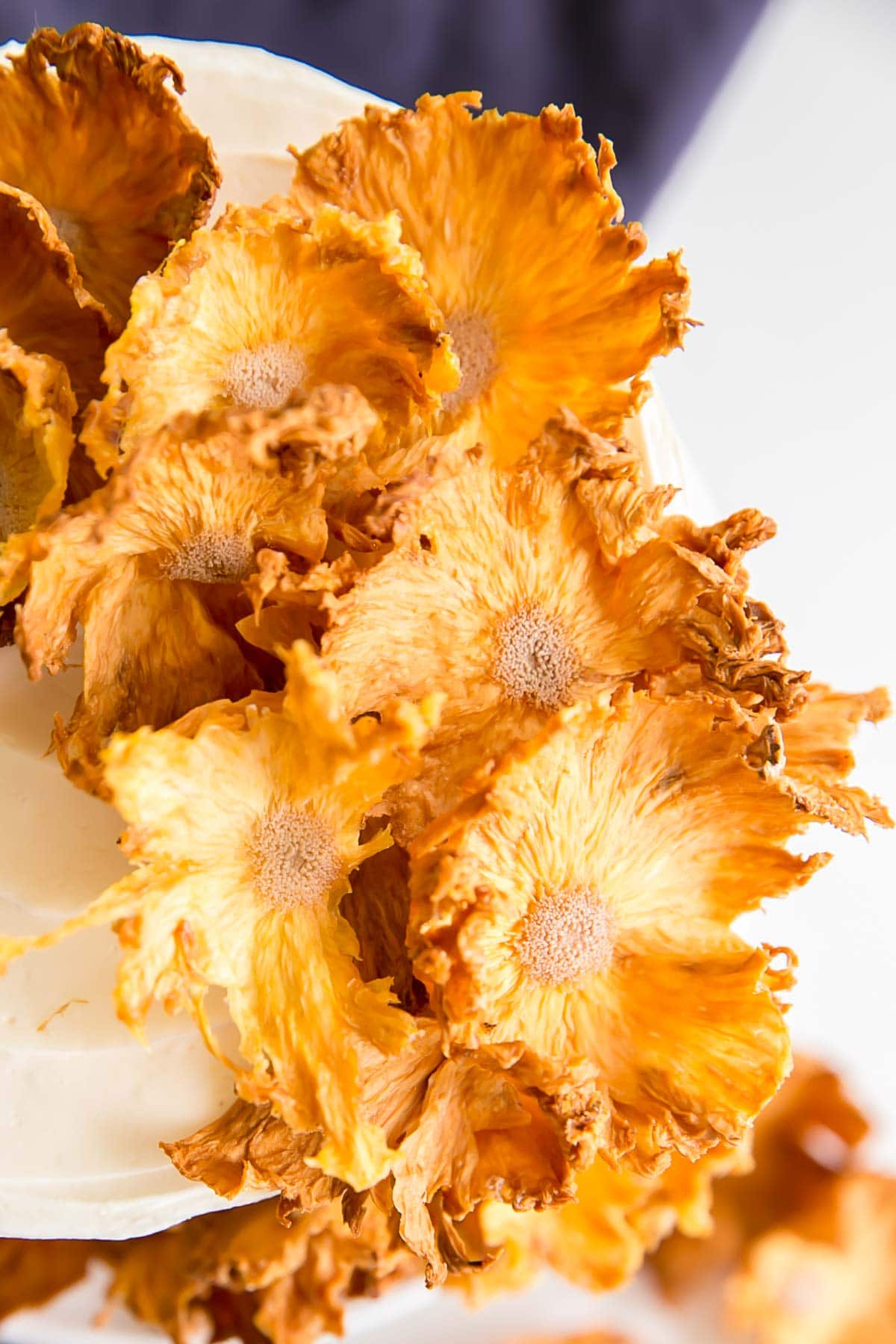Close up of dried pineapple flowers on top of a pineapple cake.