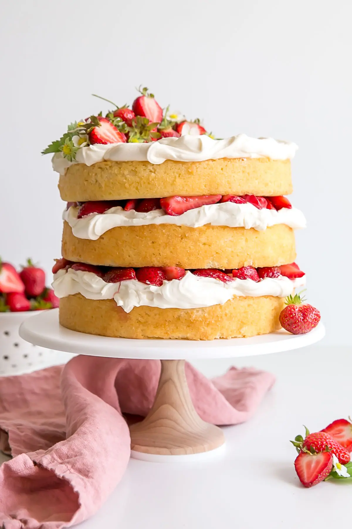 Strawberry shortcake cake decorated naked cake style.