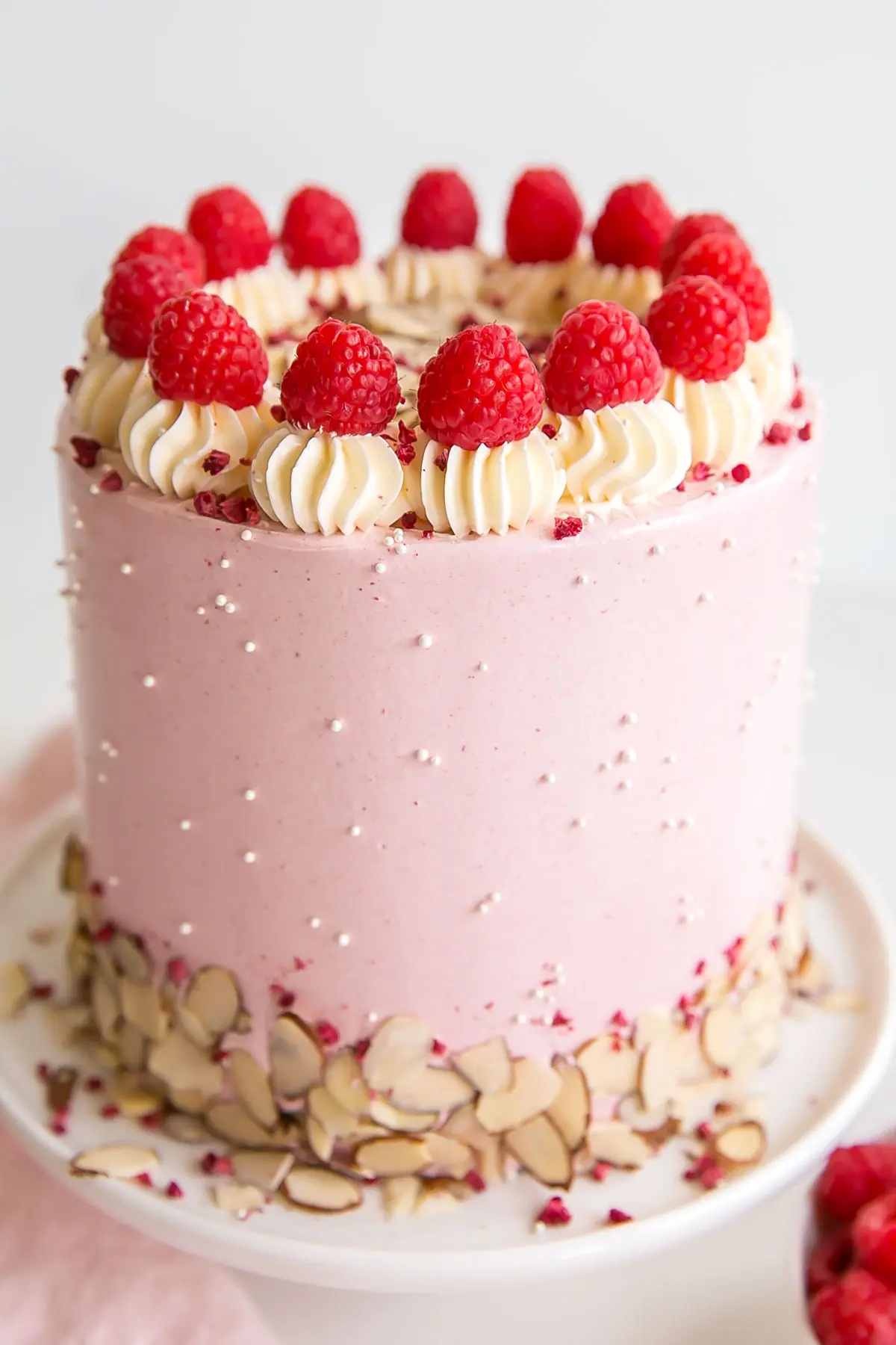 Close up showing the pink raspberry buttercream and almond buttercream dollops.