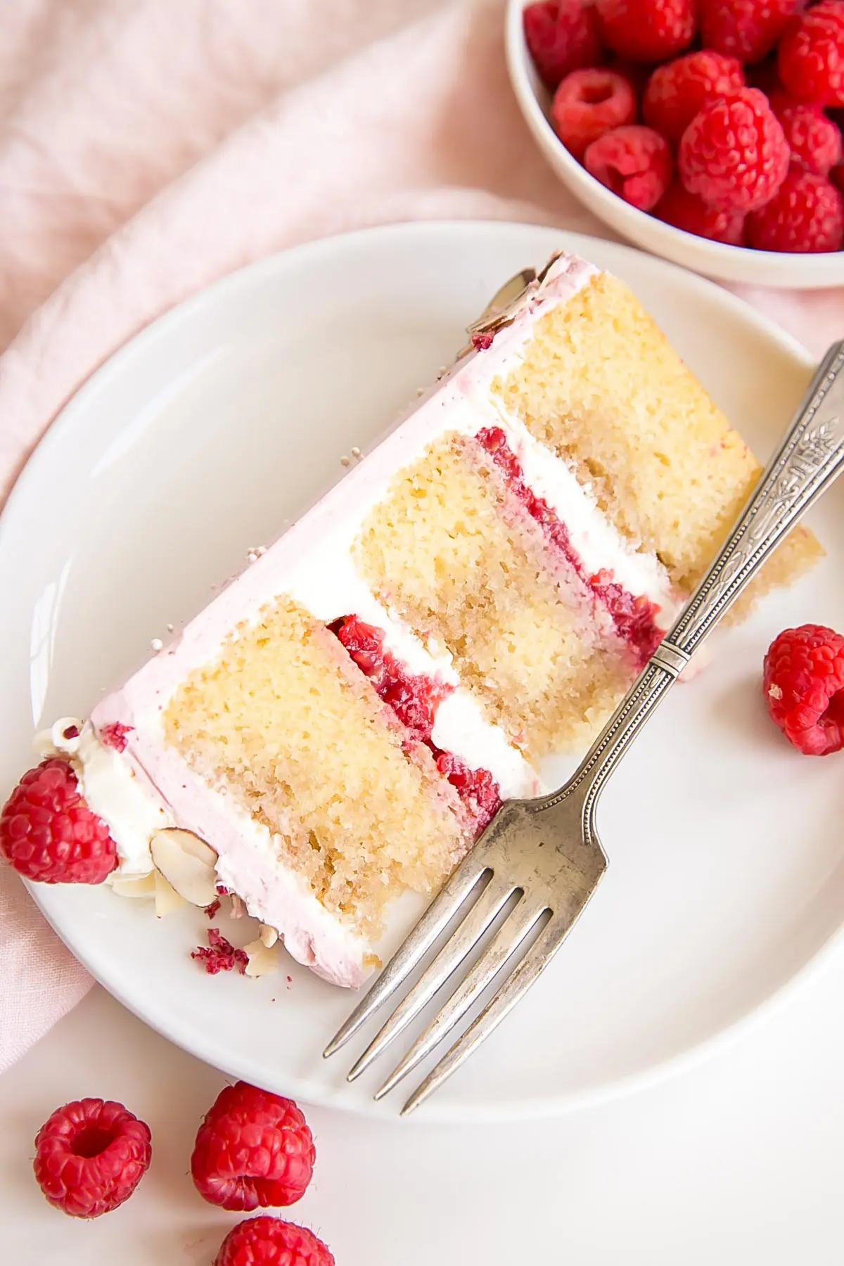 Slice of raspberry almond cake on a plate.