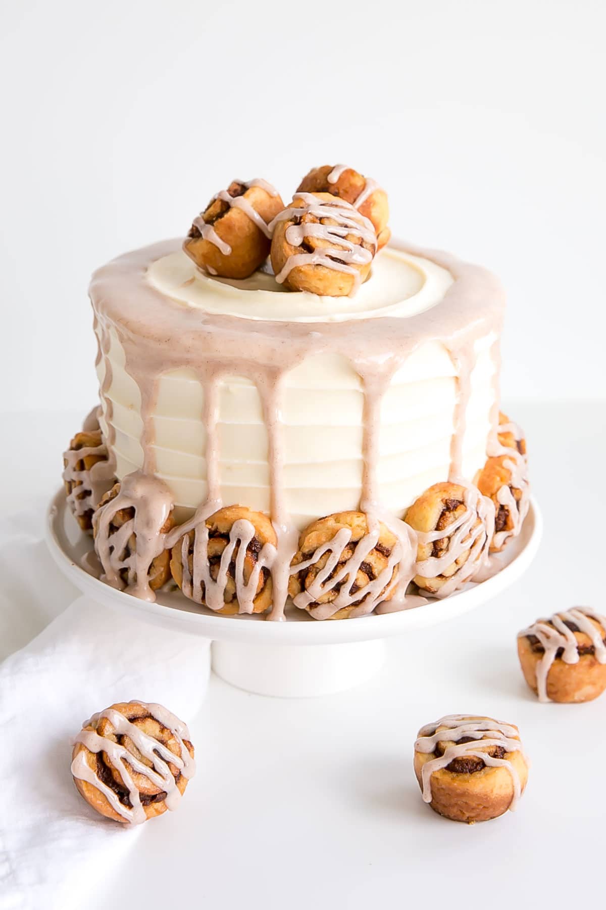 Angled shot of the cake with mini cinnamon rolls on the table.