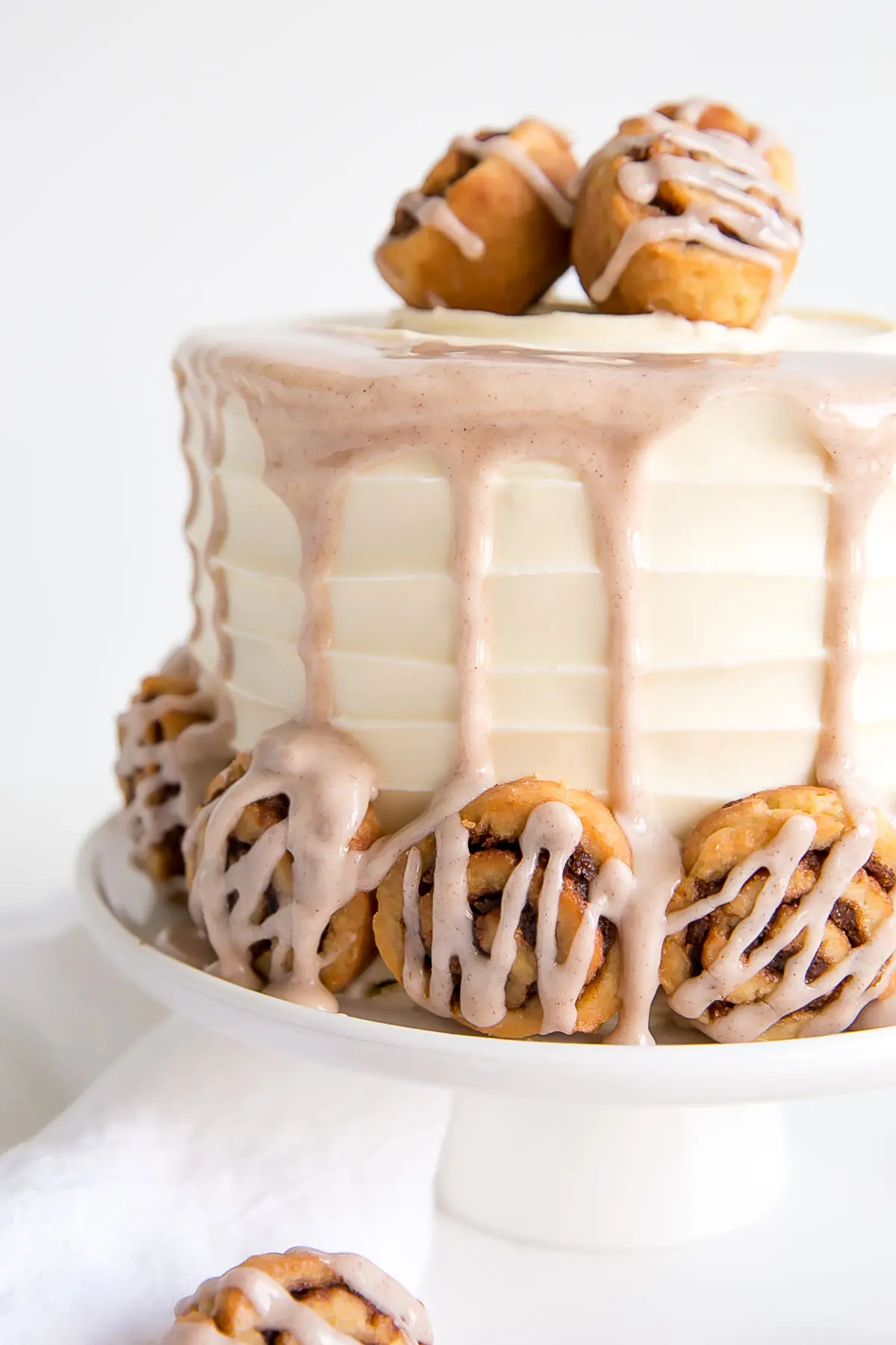 Close up of the size of the cake with mini cinnamon rolls along the bottom.