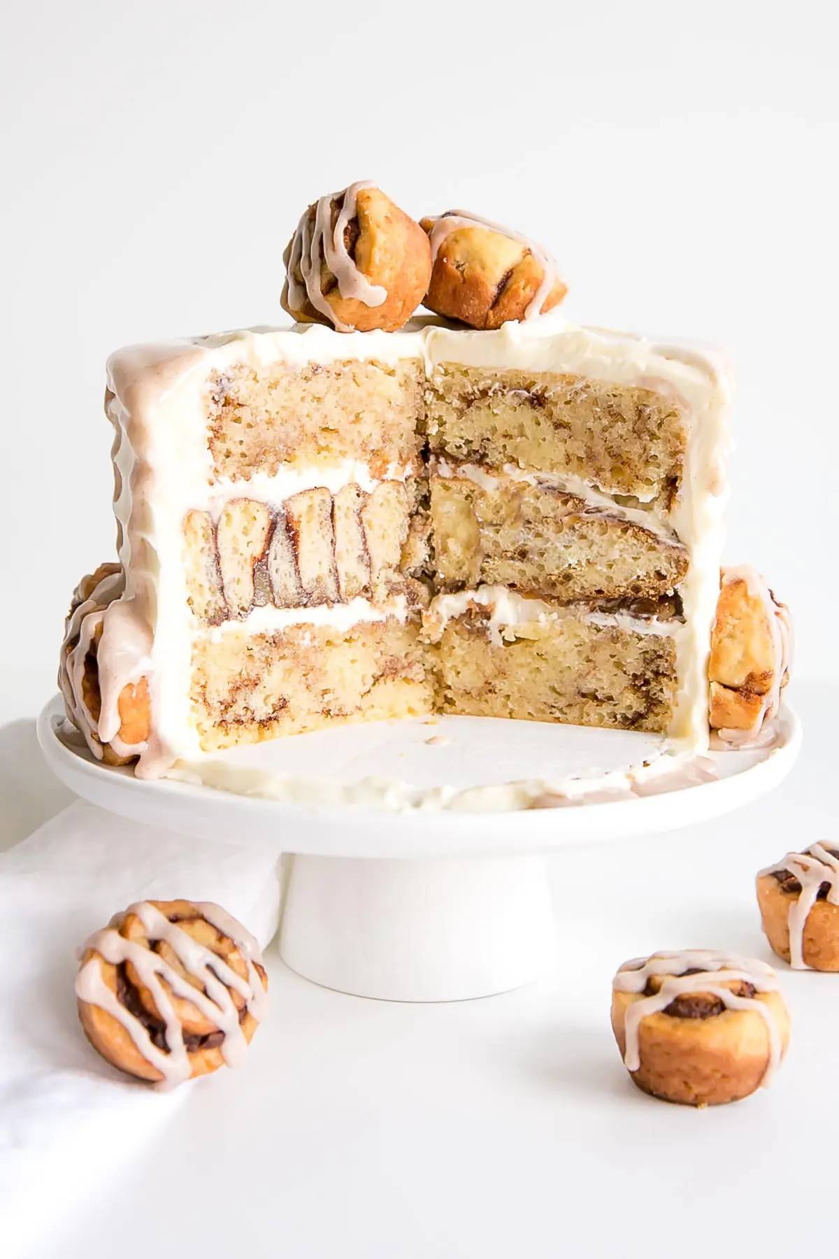 Cross section of cake showing cinnamon bun middle layer.