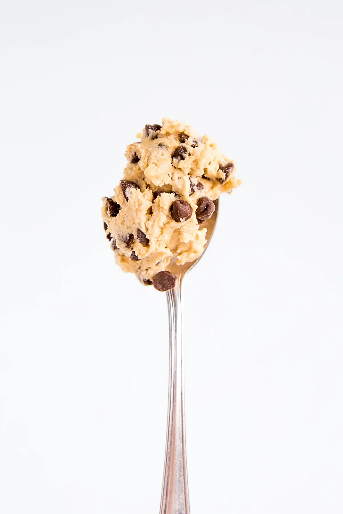 Cookie dough on a spoon.