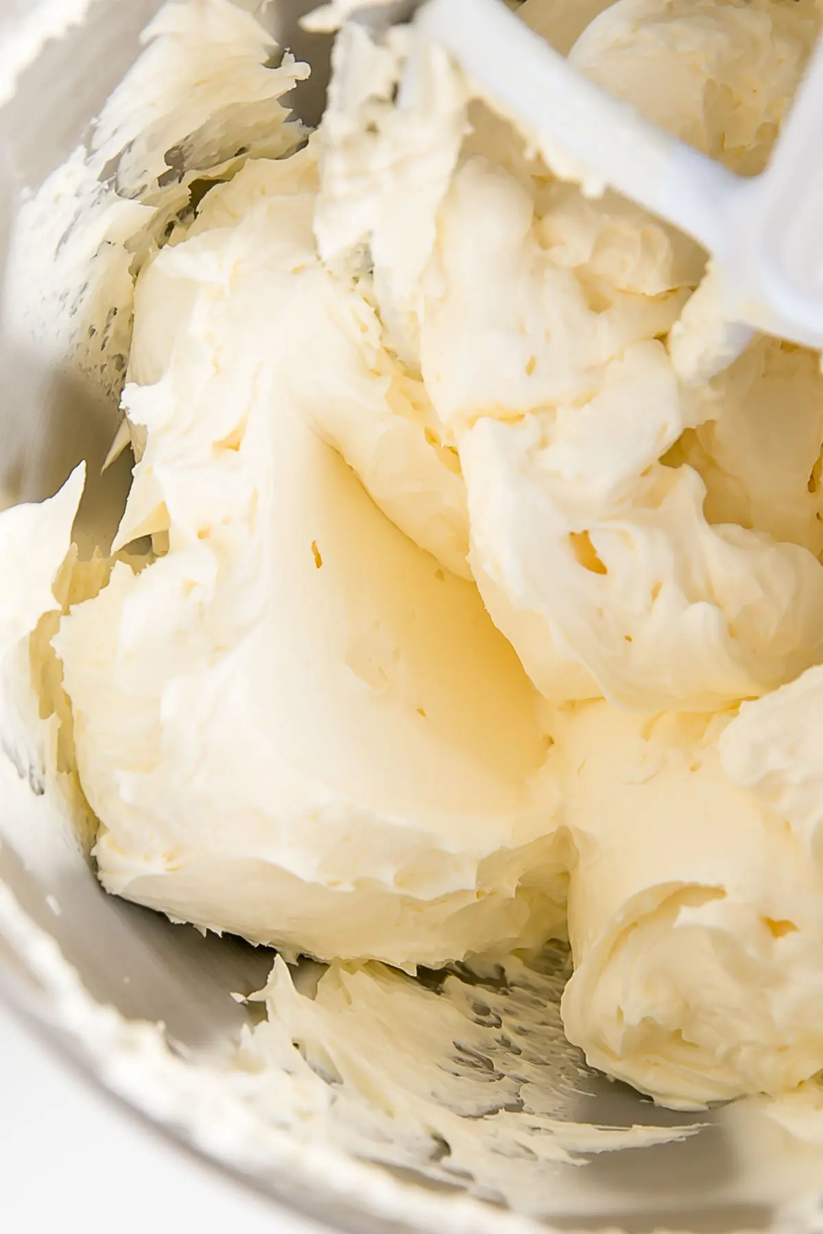 German buttercream fluffy and smooth in a stand mixer bowl.