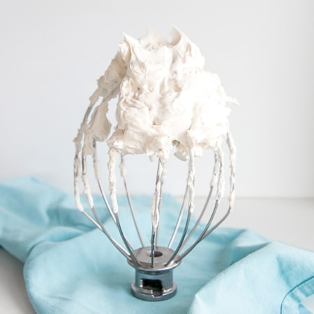 white frosting on a whisk.